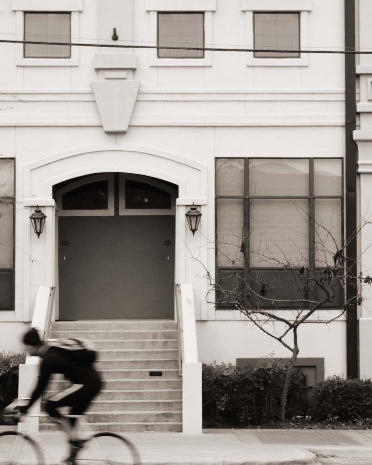 rider past a front stoop